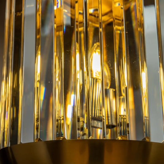 close up of 3 light brass pendant light