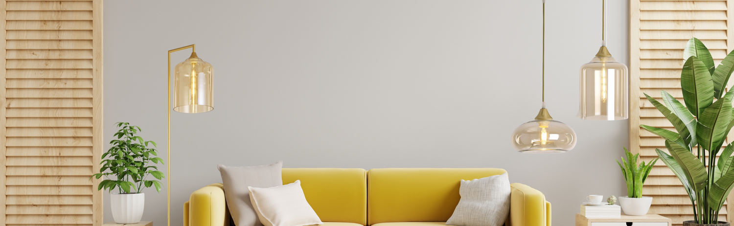 Gold pendant lights in a living room location with yellow sofa