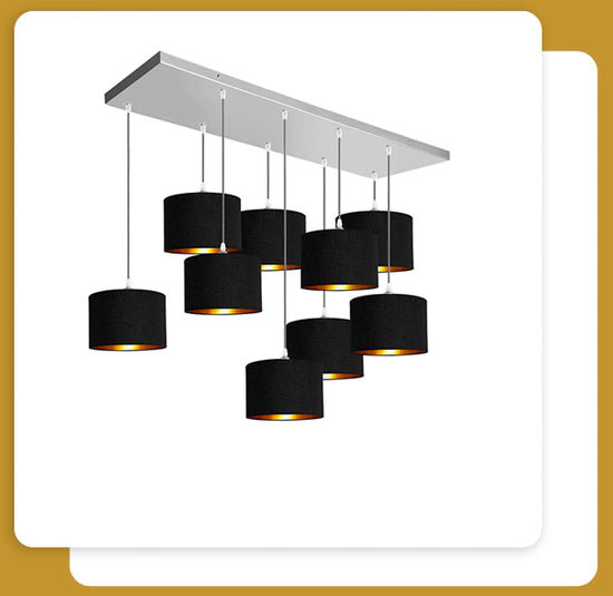 Two white cards stocked ontop of each other on a gold background. On the first black card there is a 9 light pendant light with black lampshades